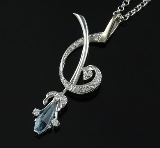 A stylish modern platinum, shaped cut aquamarine and diamond set spray pendant, on a 9ct white gold chain,